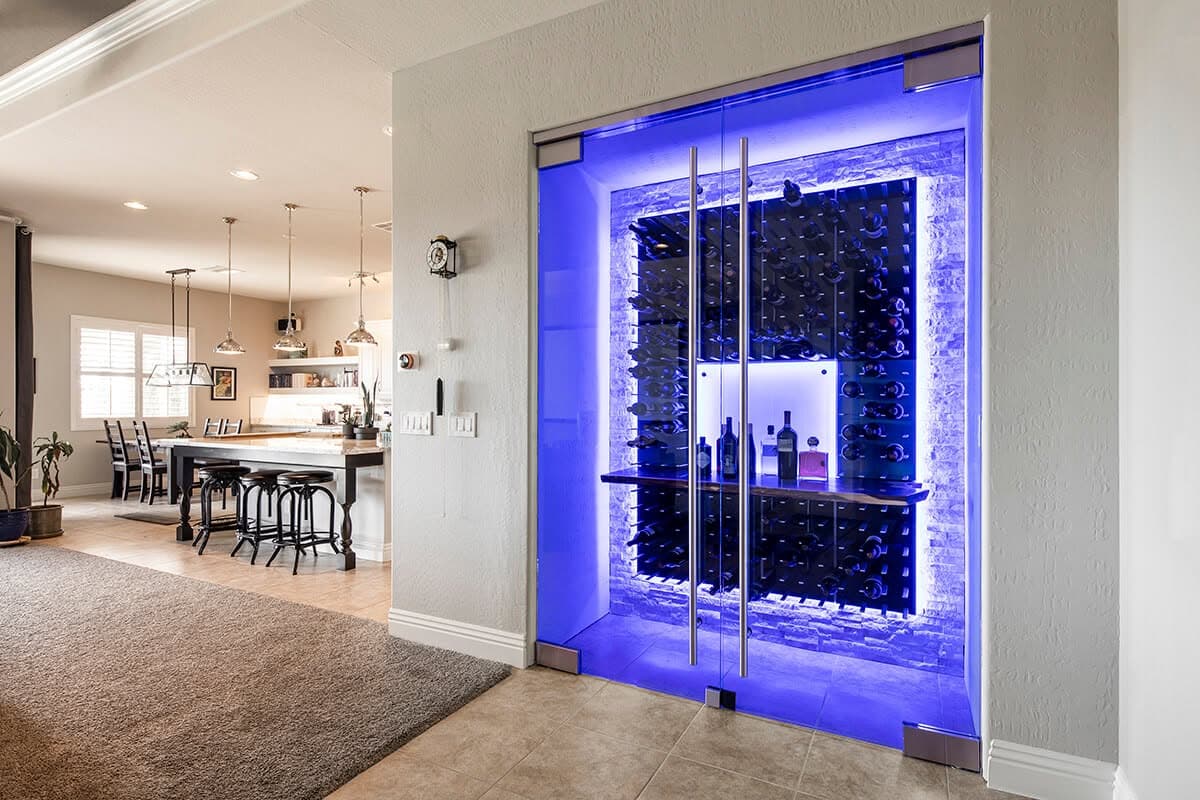 Frameless glass wine cellar enclosure with LED lighting in a Las Vegas home