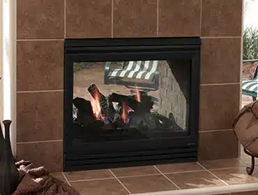 Cozy gas fireplace with a black frame, tiled surround.