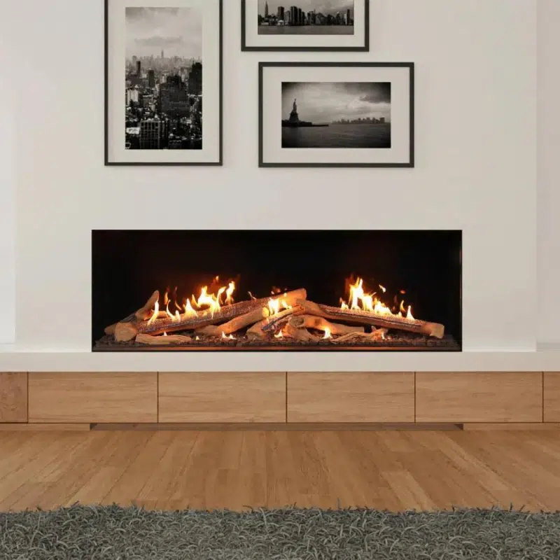 A modern living room showcases a large, rectangular fireplace with glowing flames and logs. Above the fireplaces, three black and white cityscape photos adorn the white wall. The room is completed with a wooden floor and a cozy gray rug.